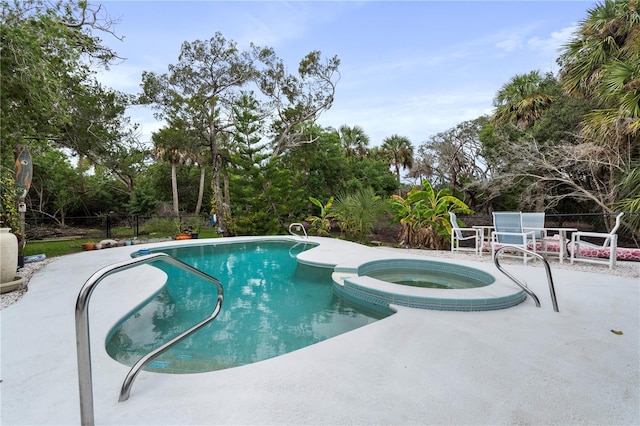 view of swimming pool with a patio and an in ground hot tub