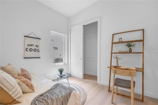 bedroom featuring light wood-type flooring and a closet