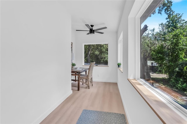 sunroom / solarium featuring ceiling fan and plenty of natural light