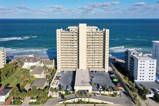 birds eye view of property featuring a water view and a beach view