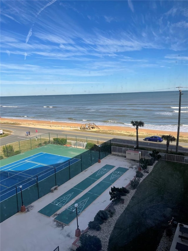 drone / aerial view with a water view and a view of the beach