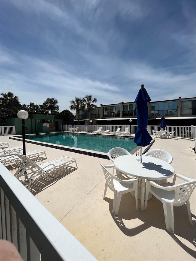 view of swimming pool with a patio