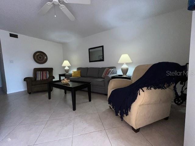 living room featuring ceiling fan and light tile patterned flooring