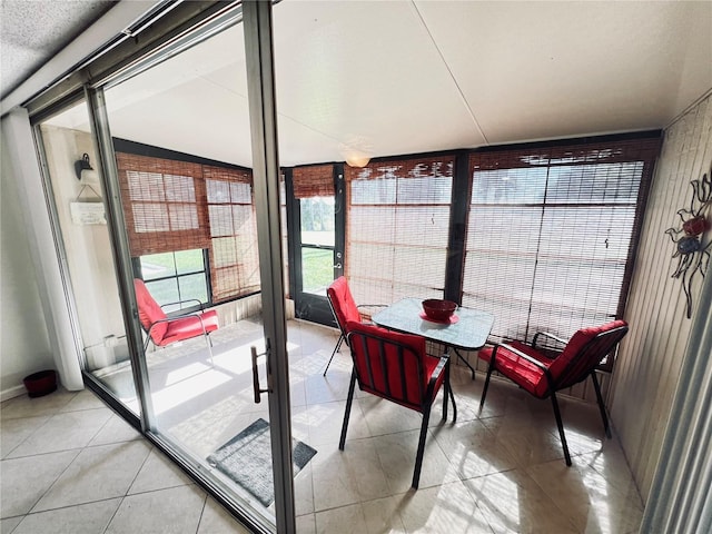 sunroom featuring vaulted ceiling