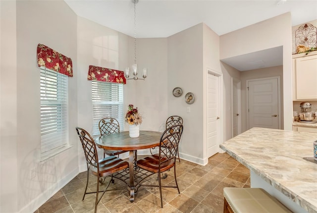 dining space featuring a chandelier and tile flooring