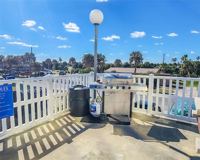 view of patio / terrace with a balcony and a grill