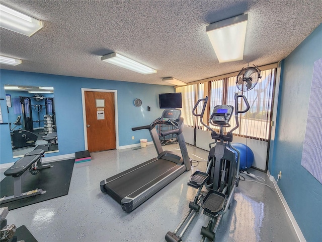 workout room featuring a textured ceiling