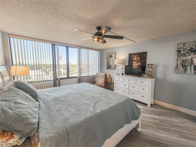 bedroom featuring a textured ceiling, ceiling fan, and dark wood-type flooring