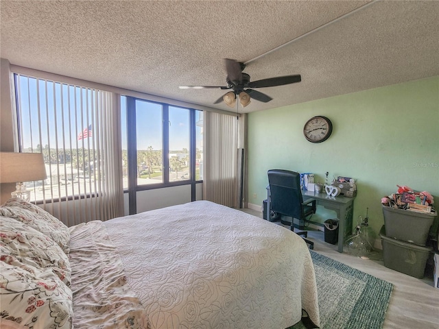 bedroom with a textured ceiling and ceiling fan