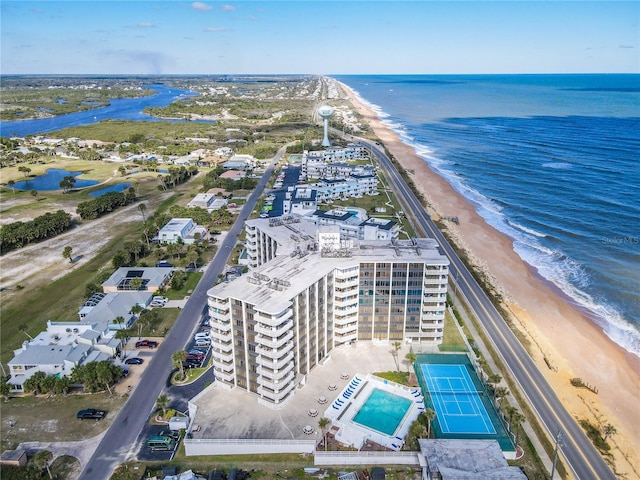 drone / aerial view featuring a water view and a view of the beach