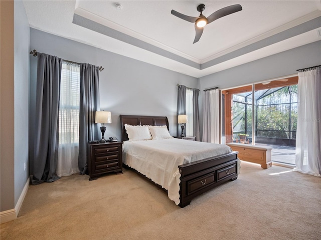 carpeted bedroom featuring a tray ceiling, ceiling fan, and access to outside