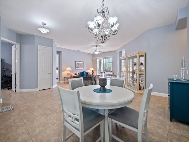 tiled dining room with ceiling fan with notable chandelier