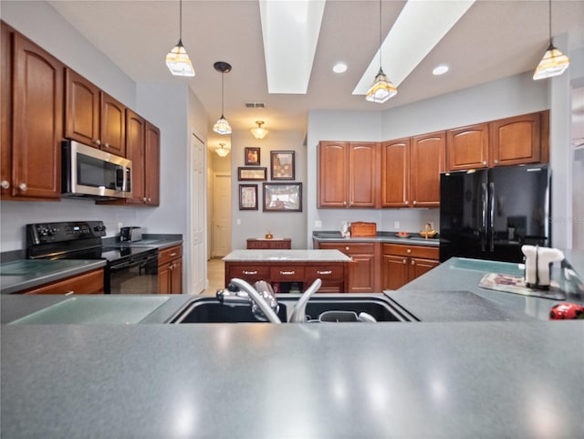 kitchen featuring a skylight, decorative light fixtures, and black appliances