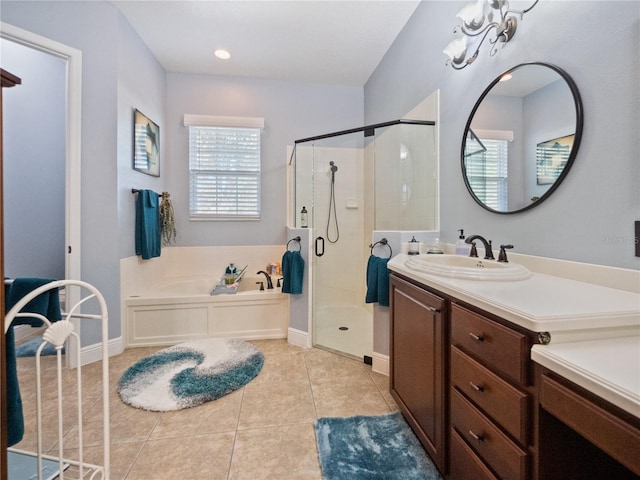 bathroom with tile floors, oversized vanity, and separate shower and tub