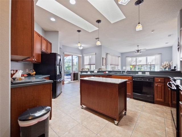 kitchen featuring a healthy amount of sunlight, pendant lighting, and black appliances