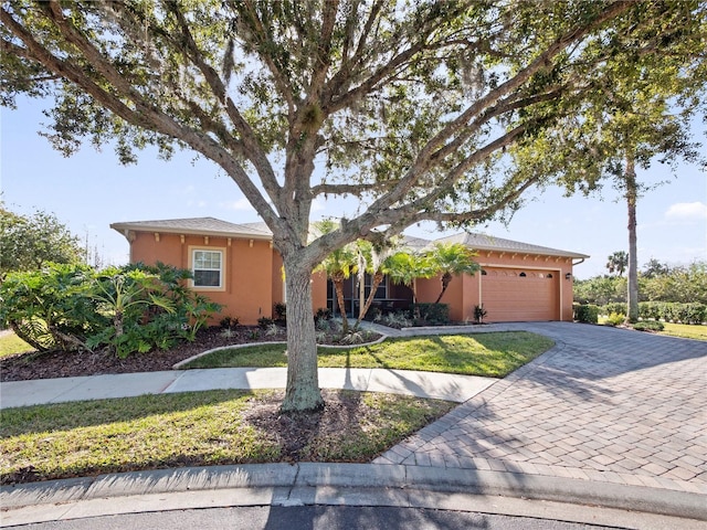 view of front of home with a garage and a front lawn