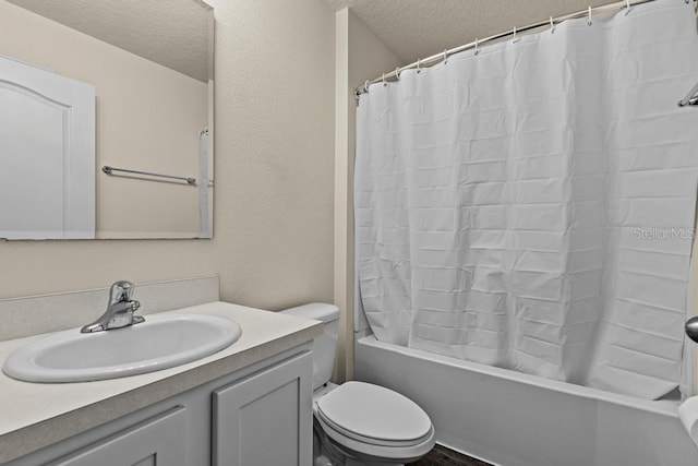 full bathroom featuring shower / bath combination with curtain, toilet, a textured ceiling, and vanity