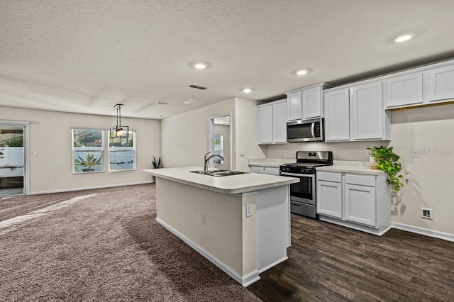 kitchen with a kitchen island with sink, white cabinetry, sink, and stainless steel appliances