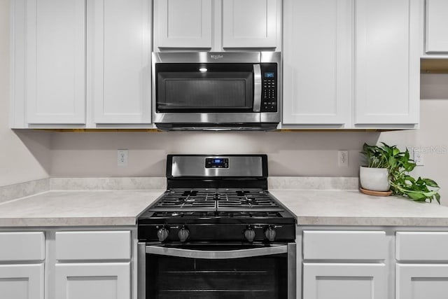 kitchen with stainless steel appliances and white cabinets