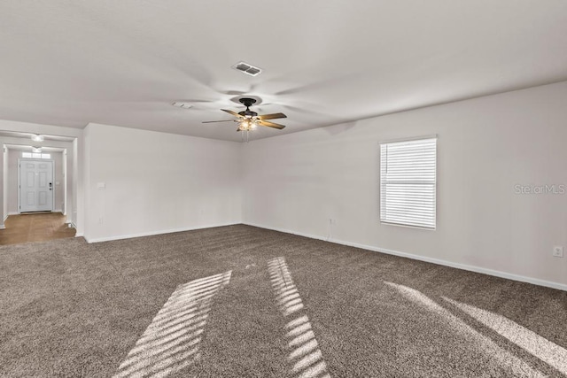 carpeted spare room with ceiling fan