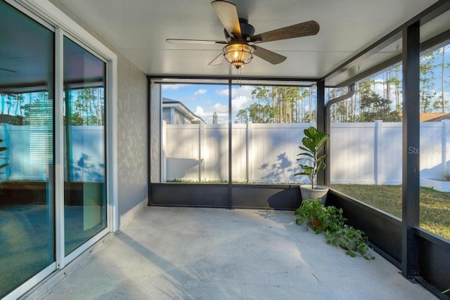 unfurnished sunroom with ceiling fan and a healthy amount of sunlight