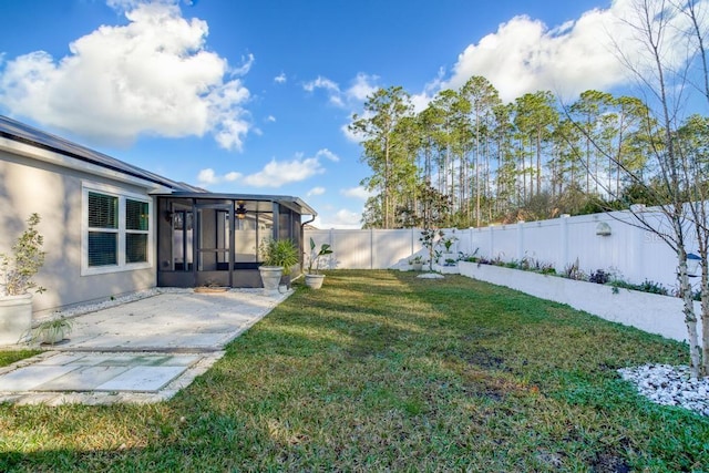 view of yard featuring a sunroom and a patio