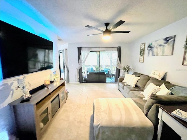 living area with a ceiling fan and light carpet