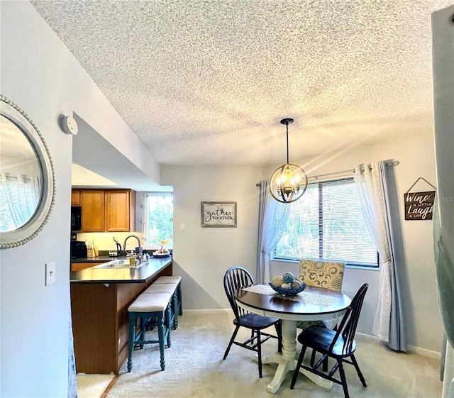 dining area featuring light colored carpet, plenty of natural light, and an inviting chandelier