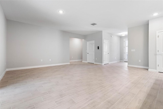 unfurnished living room with recessed lighting, visible vents, baseboards, and light wood finished floors