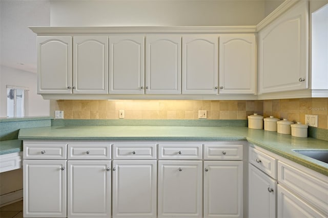 kitchen featuring tasteful backsplash and white cabinets