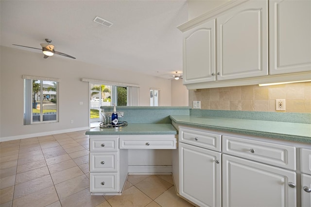 kitchen featuring light tile flooring, tasteful backsplash, ceiling fan, and white cabinetry