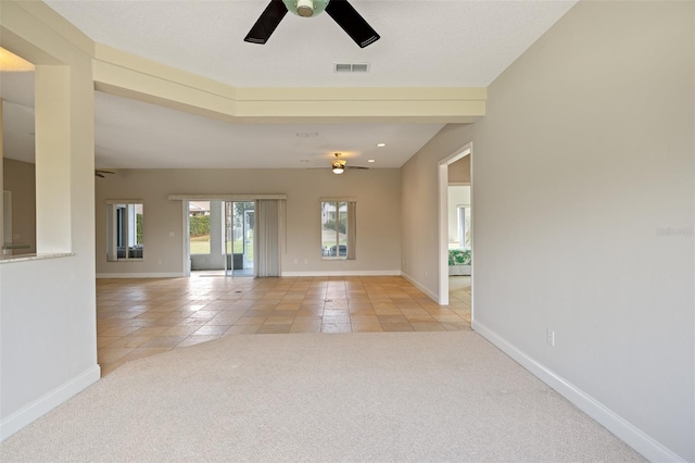 unfurnished room with ceiling fan and light tile floors