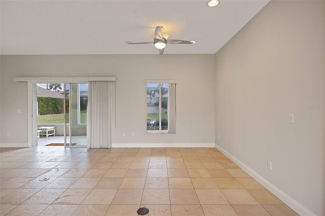 tiled spare room with ceiling fan