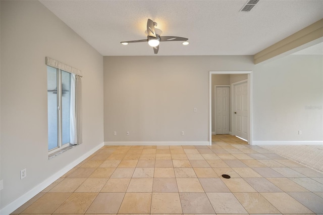 unfurnished room with light tile floors, ceiling fan, and a textured ceiling