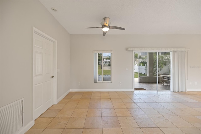 tiled spare room with ceiling fan