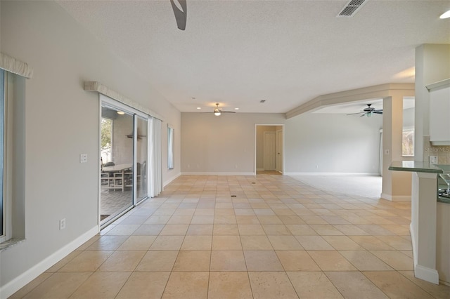 unfurnished room featuring light tile floors, ceiling fan, and a textured ceiling