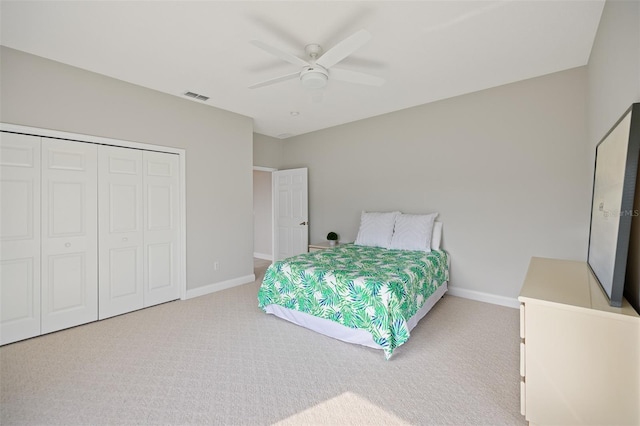 bedroom featuring a closet, light carpet, and ceiling fan