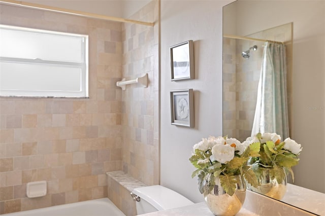 bathroom featuring shower / tub combo and toilet