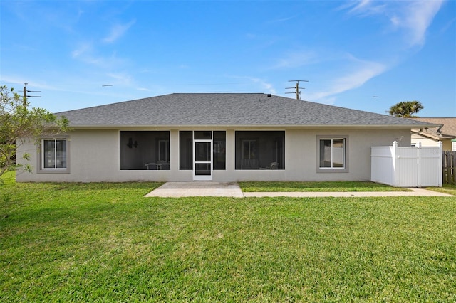 rear view of house featuring a lawn