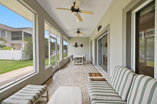 sunroom / solarium featuring ceiling fan