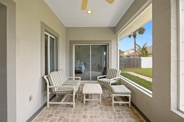 unfurnished sunroom with ceiling fan