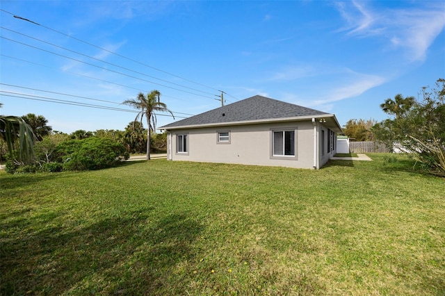 rear view of property featuring a yard