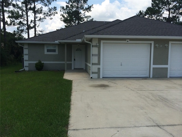 ranch-style home featuring a front lawn and a garage