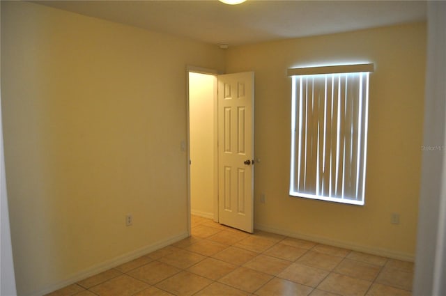 spare room with light tile flooring