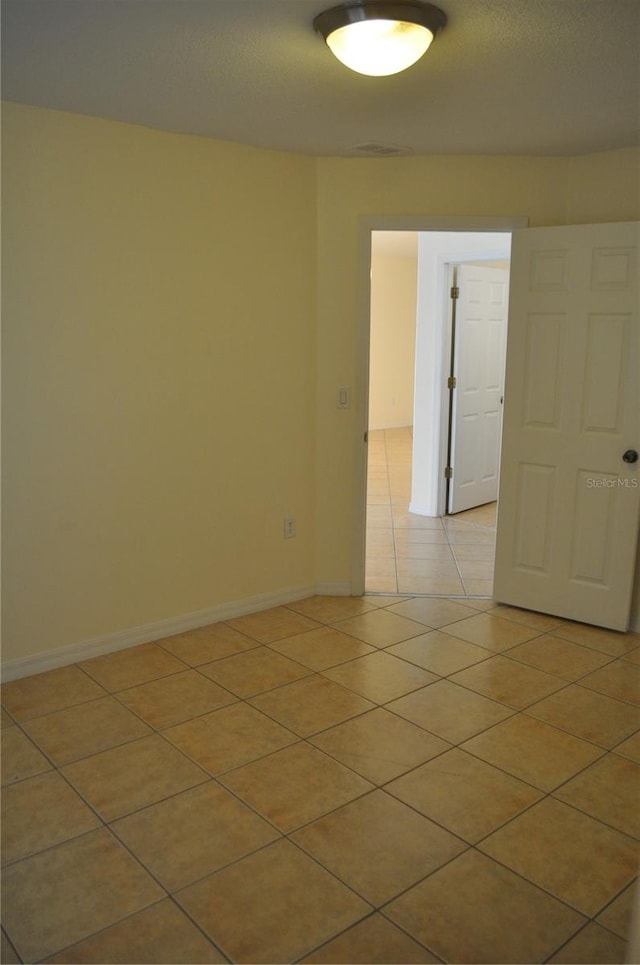 empty room featuring light tile floors