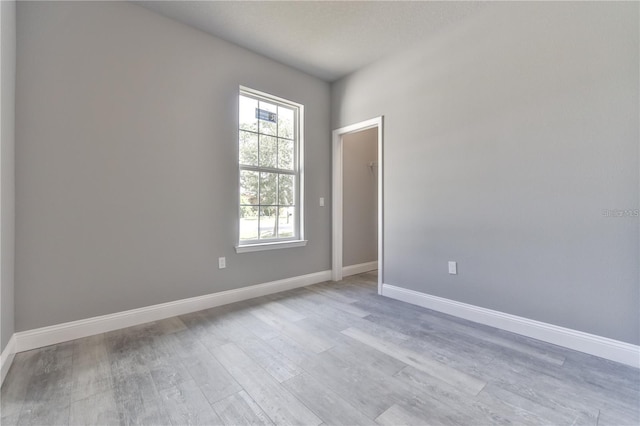 spare room with light hardwood / wood-style flooring