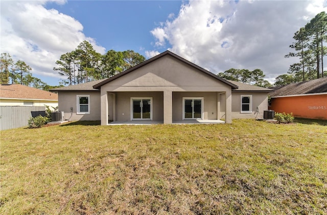 rear view of house with a patio area, central AC, and a lawn