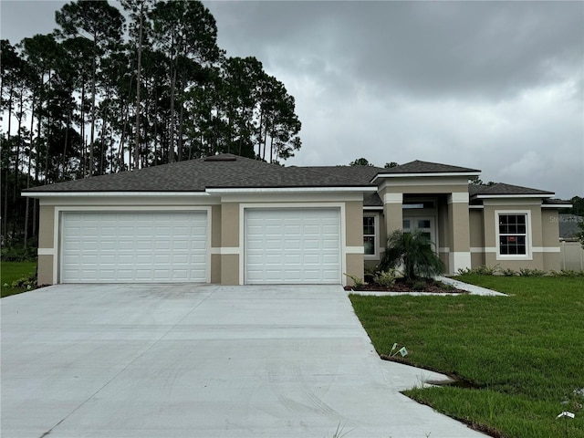 view of front of property featuring a garage and a front yard