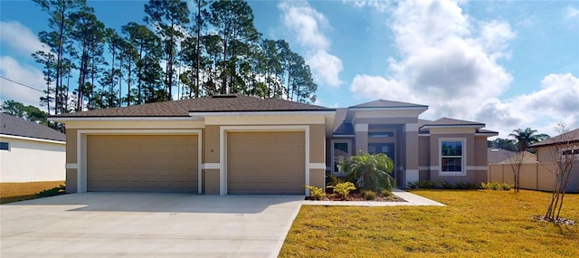 prairie-style home with an attached garage, a front yard, concrete driveway, and stucco siding