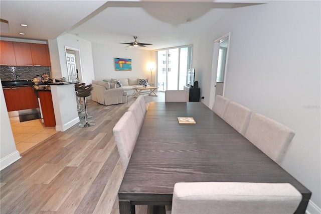 dining space featuring light hardwood / wood-style floors and ceiling fan